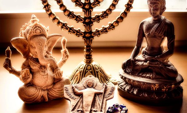items symbolizing major world religions on a table